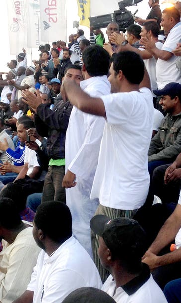 In Qatar, migrant workers paid to be sports 'fans'